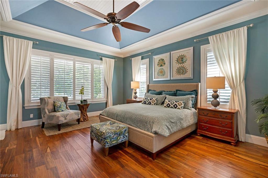 150 Central Avenue Naples, FL 34102 - Photo 9 of 35 a bedroom with a bed couch and windows