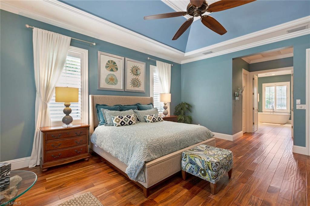 150 Central Avenue Naples, FL 34102 - Photo 10 of 35 a bedroom with a bed mirror and a window