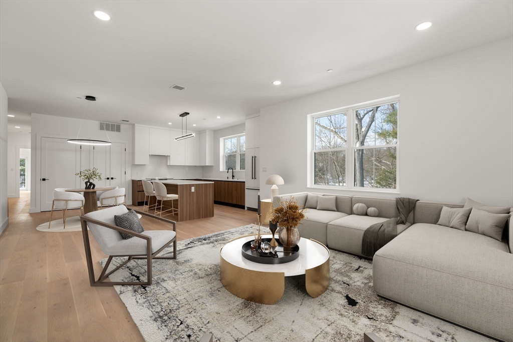 16 Stearns Road, Unit 106 Wellesley, MA 02482 - Photo 5 of 12 a living room with furniture and a large window