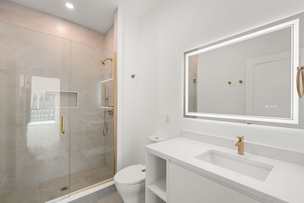 16 Stearns Road, Unit 106 Wellesley, MA 02482 - Photo 6 of 12 a bathroom with a sink a toilet and shower