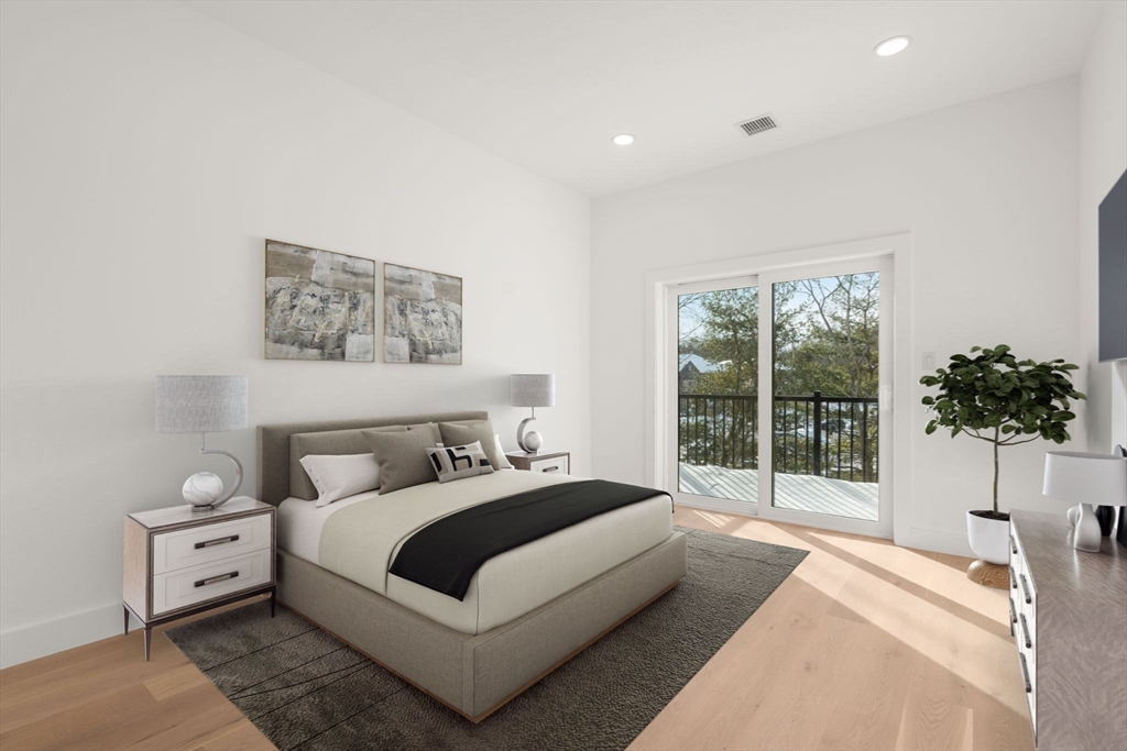 16 Stearns Road, Unit 106 Wellesley, MA 02482 - Photo 7 of 12 a bedroom with a large bed and a large window