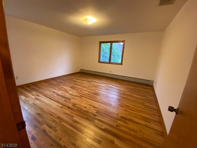 141 Prospect Street Nutley, NJ 07110 - Photo 12 of 18 an empty room with wooden floor and windows