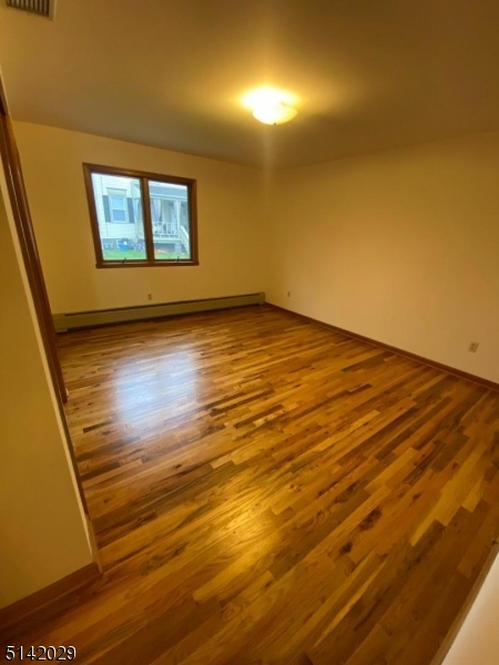 141 Prospect Street Nutley, NJ 07110 - Photo 13 of 18 a view of an empty room with wooden floor and a window