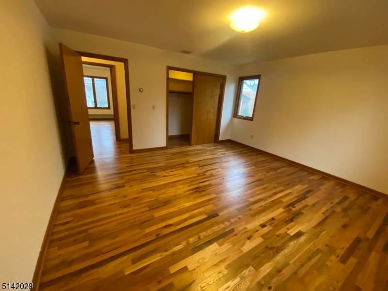141 Prospect Street Nutley, NJ 07110 - Photo 14 of 18 a view of an empty room with window and wooden floor