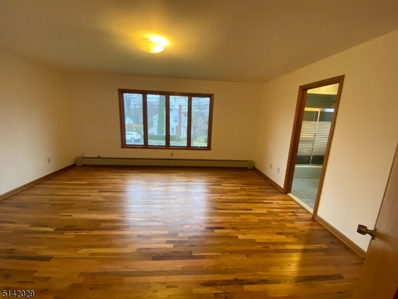 141 Prospect Street Nutley, NJ 07110 - Photo 15 of 18 a view of empty room with wooden floor and fan