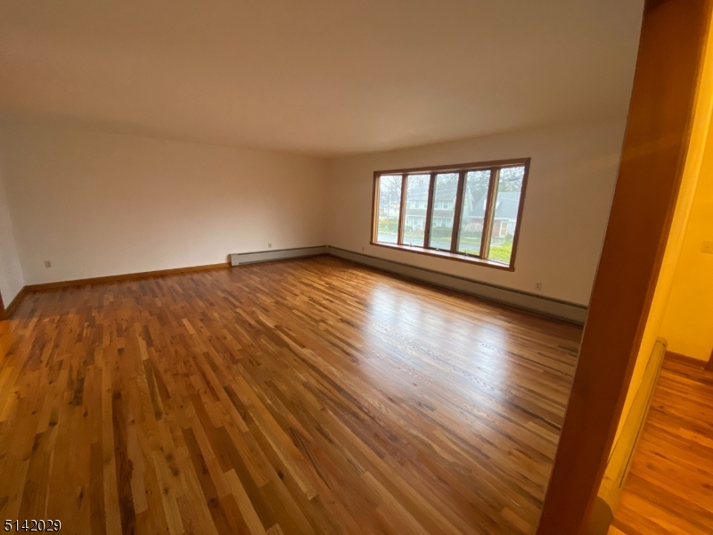 141 Prospect Street Nutley, NJ 07110 - Photo 2 of 18 a view of empty room with wooden floor and fan