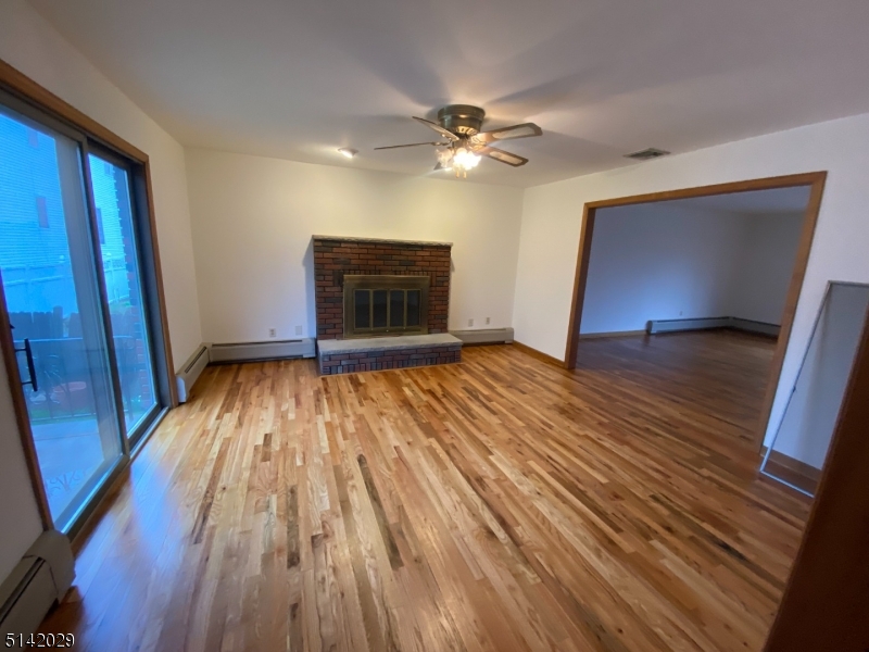 141 Prospect Street Nutley, NJ 07110 - Photo 5 of 18 a view of empty room with wooden floor and fan