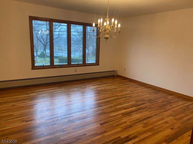 141 Prospect Street Nutley, NJ 07110 - Photo 9 of 18 a view of empty room with wooden floor and fan