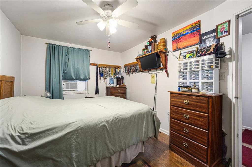 7148 Vann Road Pittsburgh, PA 15206 - Photo 16 of 36 a bedroom with a bed and a chandelier