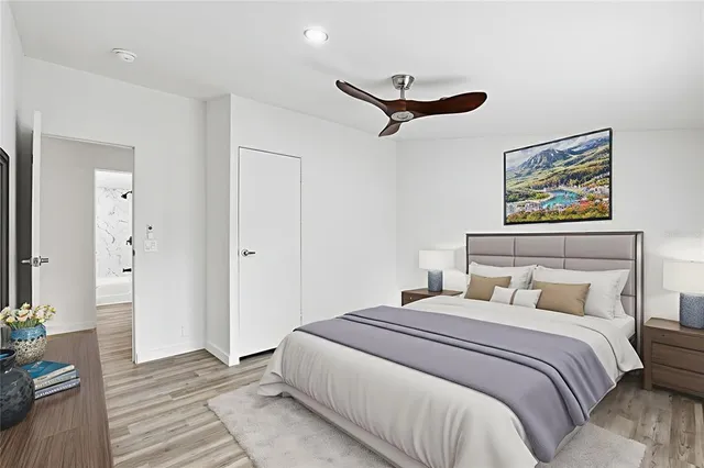 a bedroom with a bed and a painting on the wall