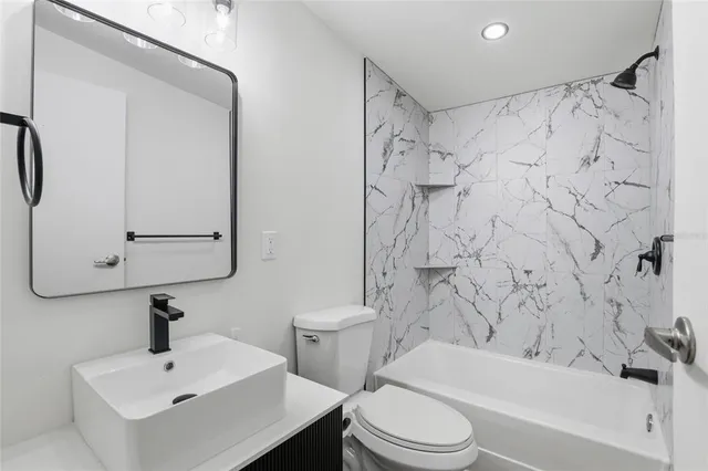 a bathroom with a sink toilet and shower