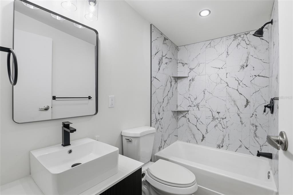 9024 Southwest 104th Terrace Gainesville, FL 32608 - Photo 12 of 21 a bathroom with a sink toilet and shower
