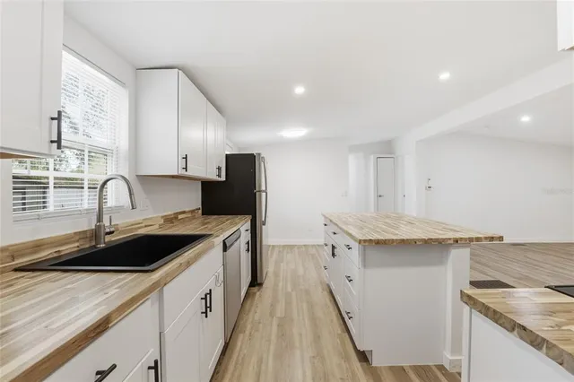a kitchen with a sink stove and cabinets