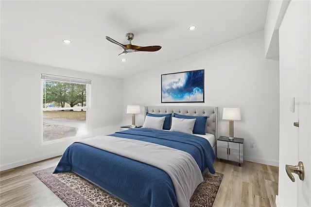 a bedroom with bed and a window