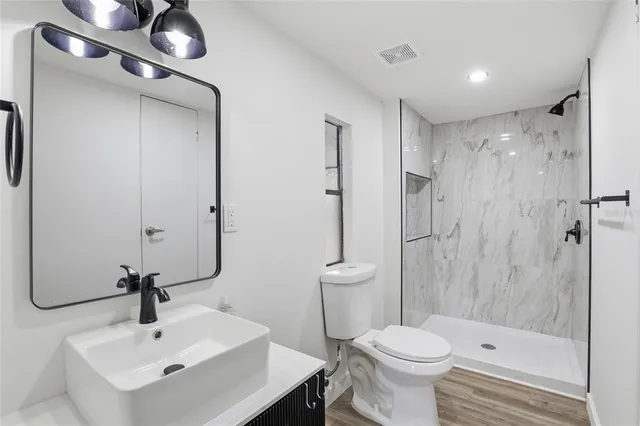 a bathroom with a sink toilet and shower