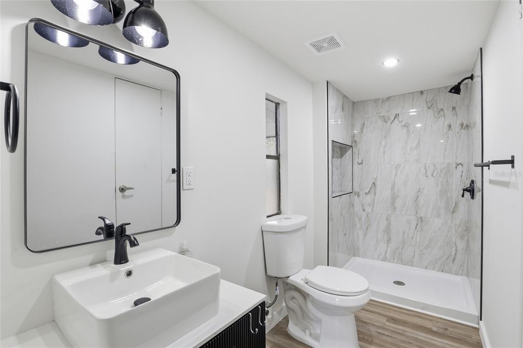9024 Southwest 104th Terrace Gainesville, FL 32608 - Photo 9 of 21 a bathroom with a sink toilet and shower