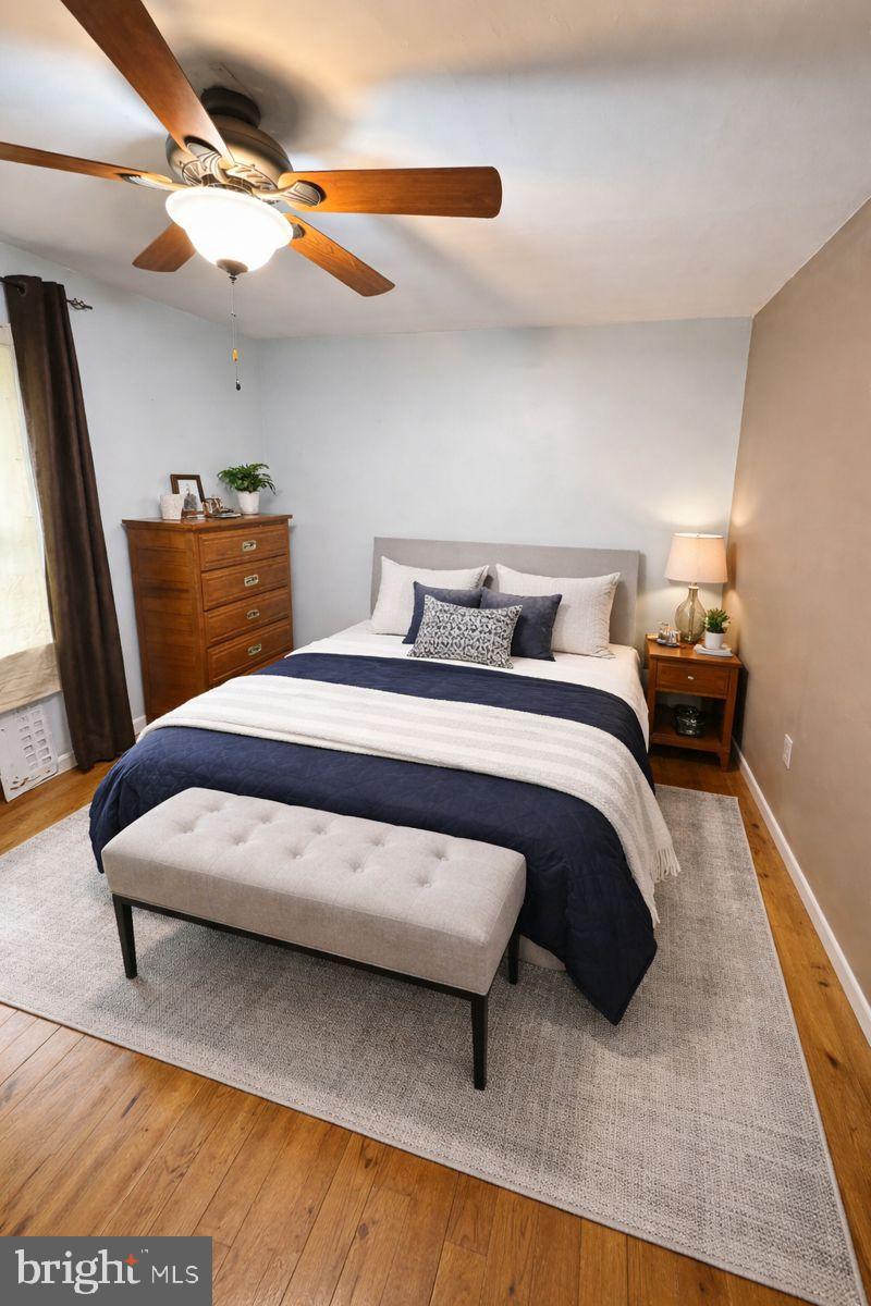 91 Mountain Road Rising Sun, MD 21911 - Photo 5 of 17 a bedroom with a bed and wooden floor