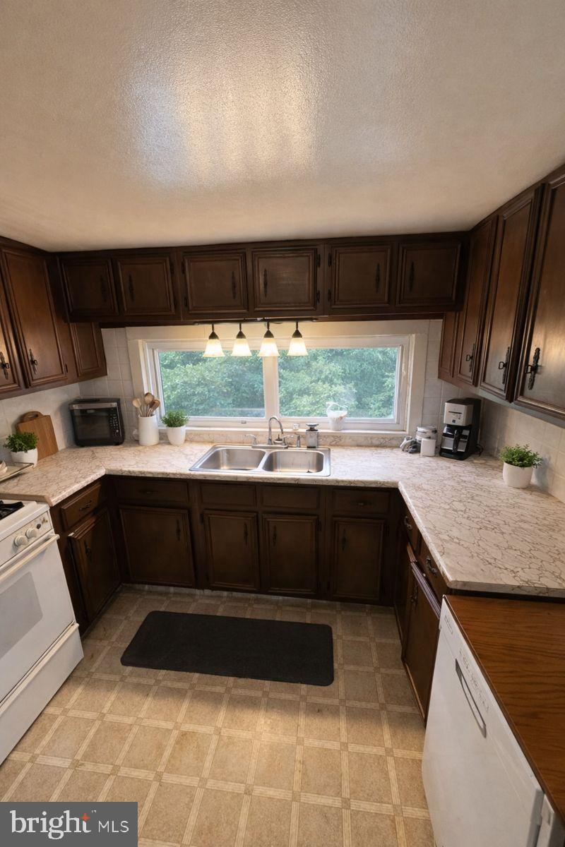 91 Mountain Road Rising Sun, MD 21911 - Photo 6 of 17 a kitchen with a large counter top space appliances and cabinets