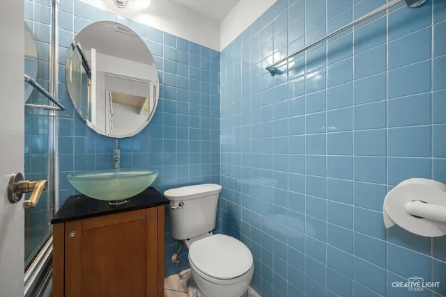 a bathroom with a toilet a sink and a mirror