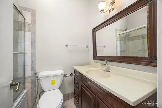 a bathroom with a sink mirror vanity and toilet