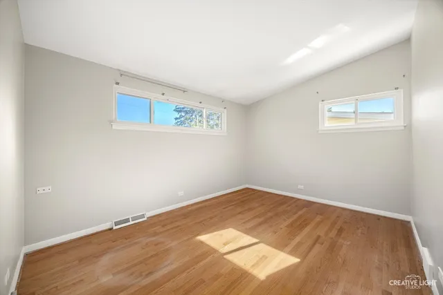 an empty room with wooden floor