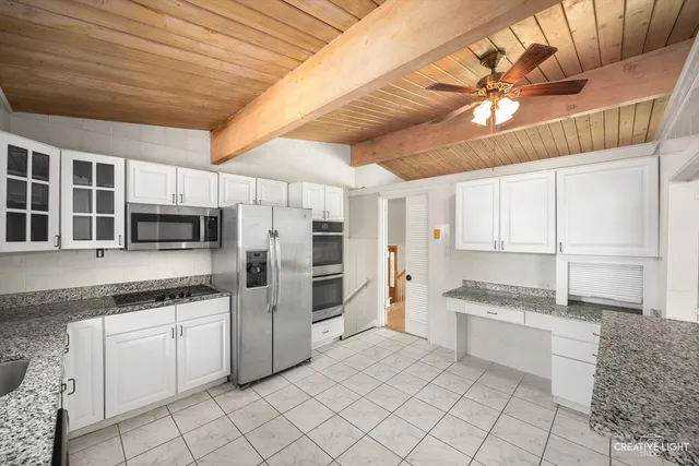 a kitchen with stainless steel appliances granite countertop a stove and a refrigerator