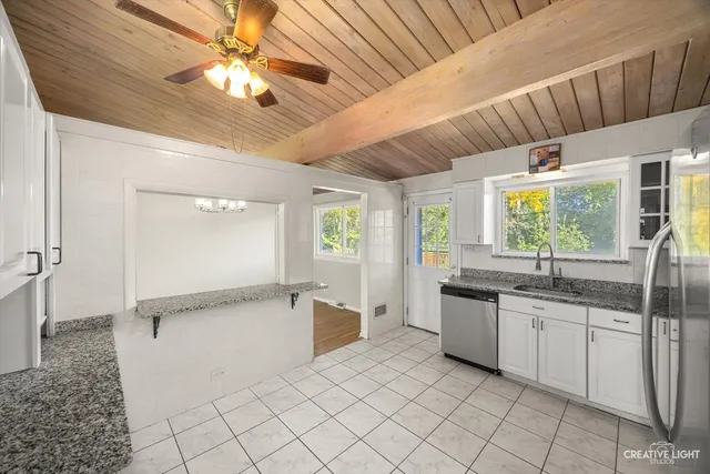 a kitchen with granite countertop a sink and a stove top oven