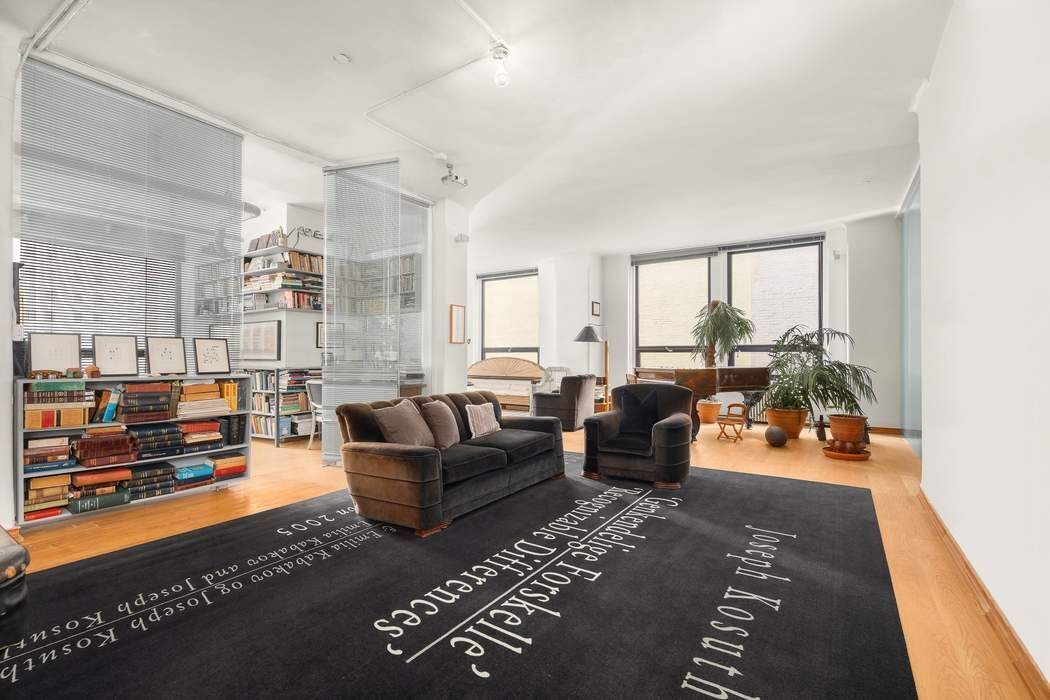 50 Pine Street, Unit 10 Manhattan, NY 10005 - Photo 11 of 14 a living room with furniture and a table