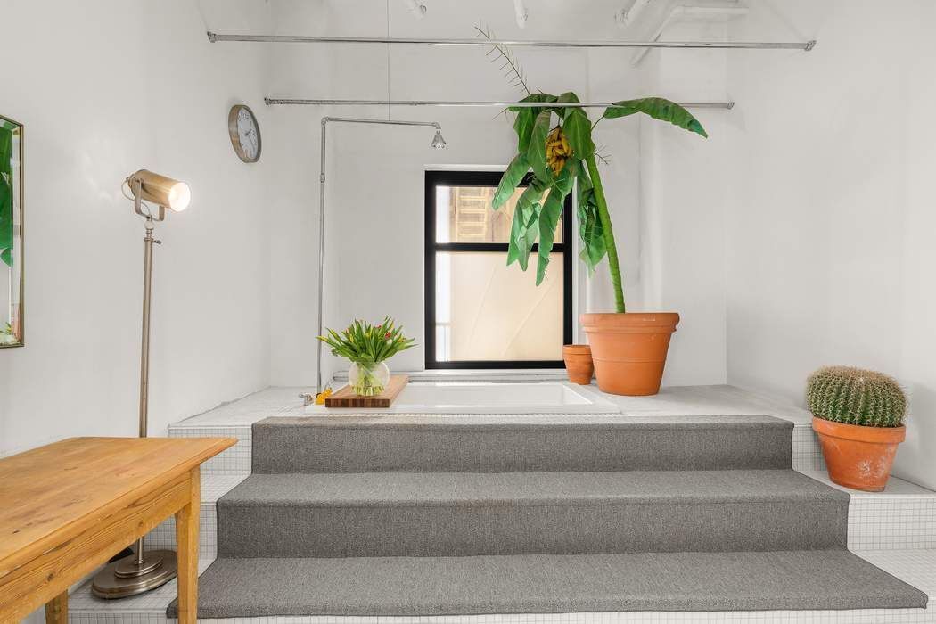 50 Pine Street, Unit 10 Manhattan, NY 10005 - Photo 8 of 14 a bedroom with a bed and a potted plant