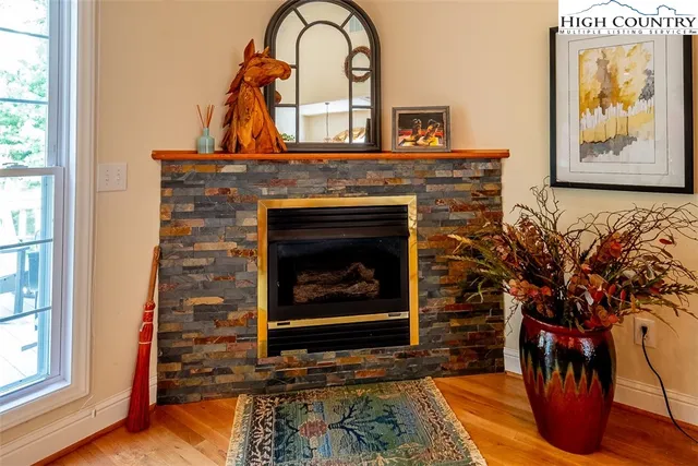 a living room with a fireplace and a potted plant