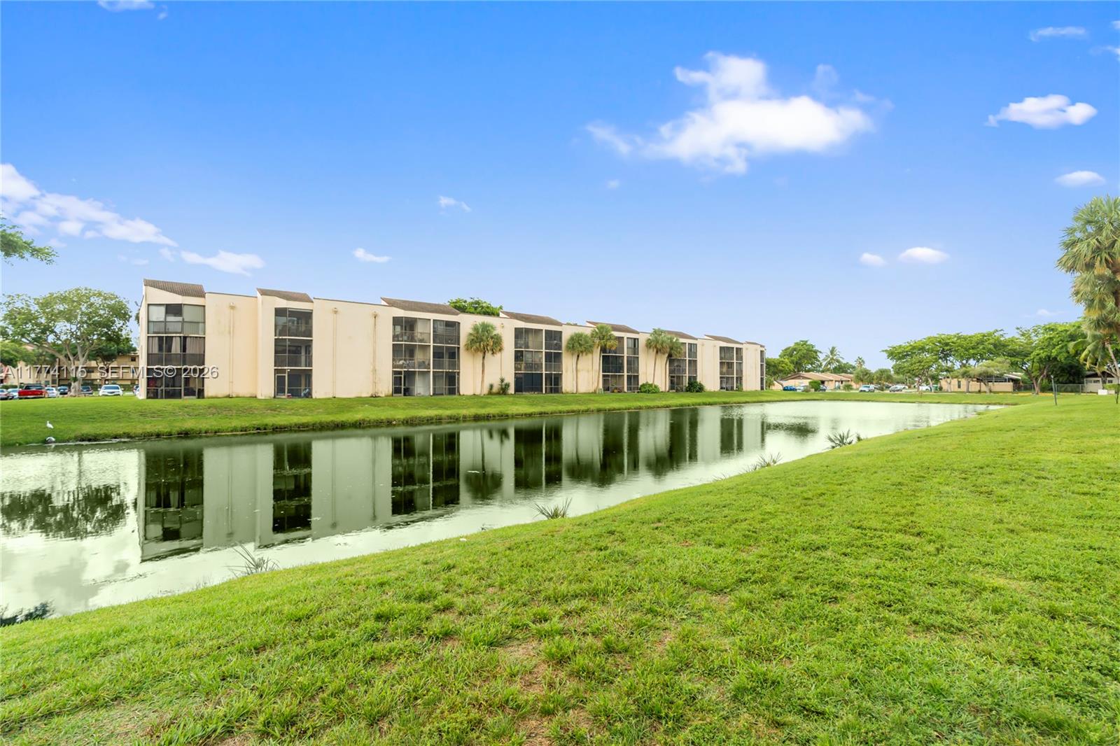 3199 Foxcroft Road, Unit 311 Miramar, FL 33025 - Photo 14 of 18 a view of swimming pool with a garden and plants