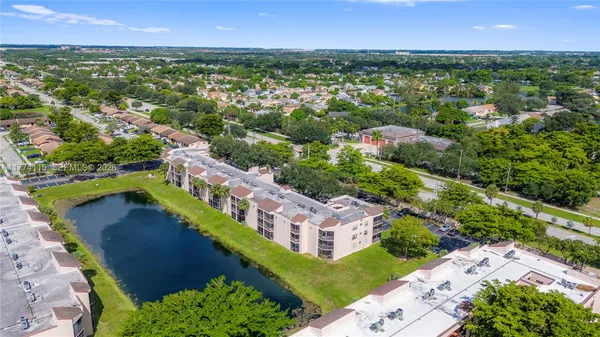 an aerial view of residential houses with outdoor space and river