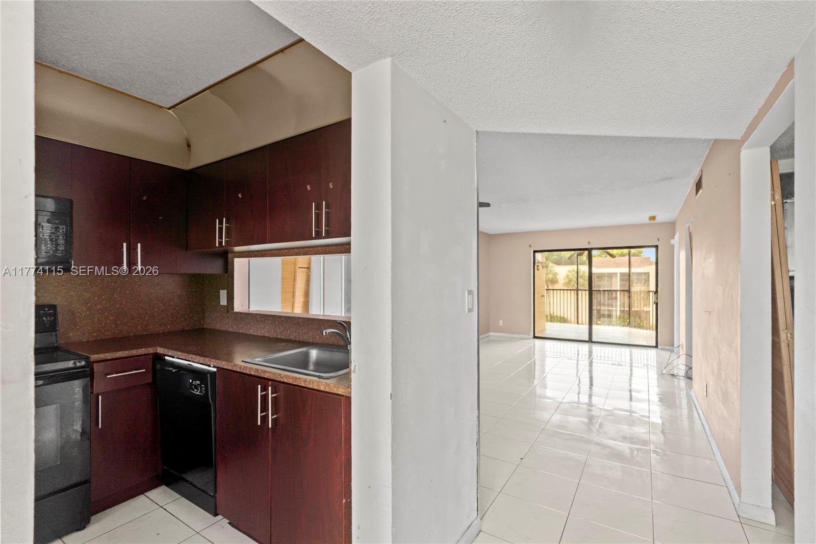 3199 Foxcroft Road, Unit 311 Miramar, FL 33025 - Photo 2 of 18 a kitchen with stainless steel appliances granite countertop a stove and a refrigerator