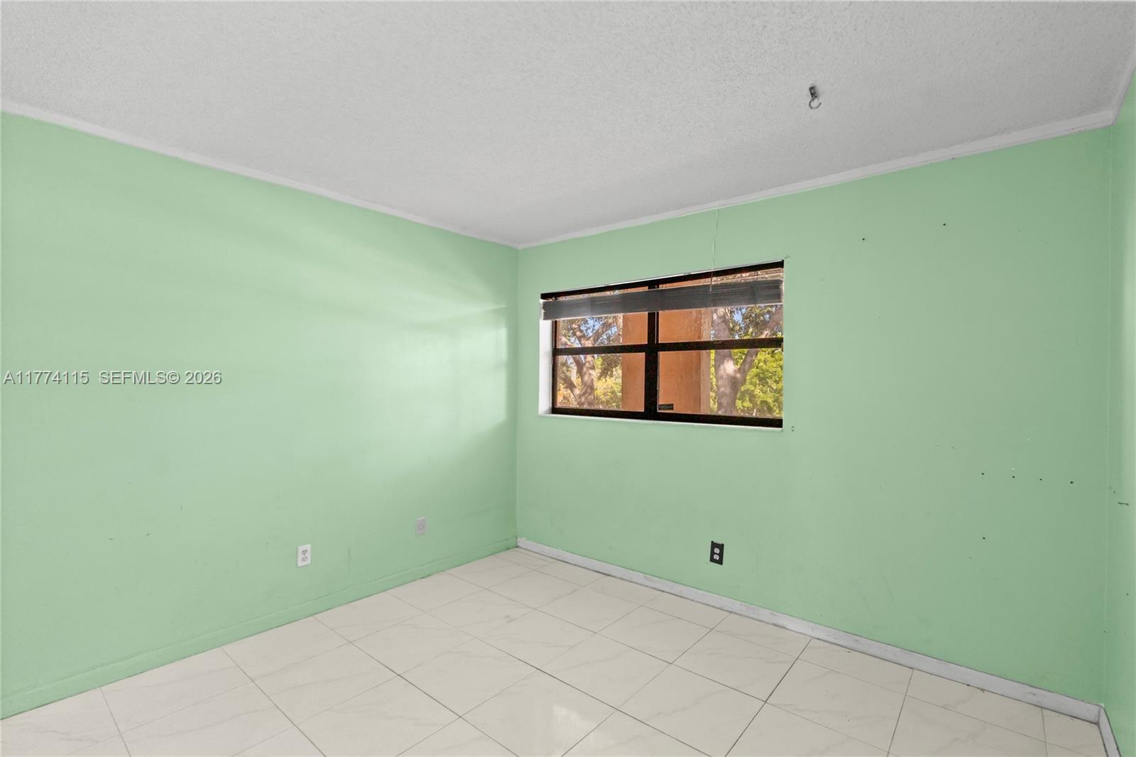 3199 Foxcroft Road, Unit 311 Miramar, FL 33025 - Photo 6 of 18 a view of an empty room with window