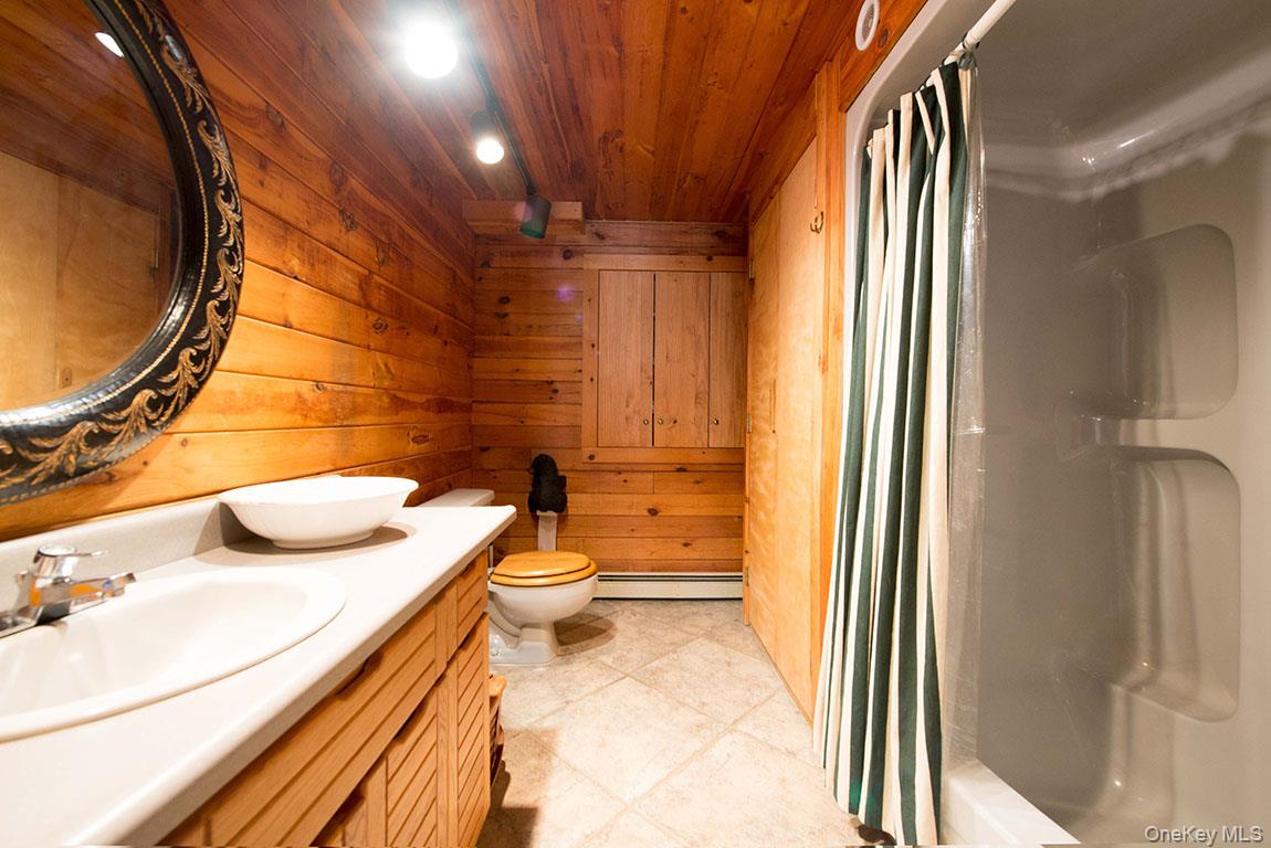 1644 Lakes Road Monroe, NY 10950 - Photo 27 of 49 a bathroom with a granite countertop sink and a mirror