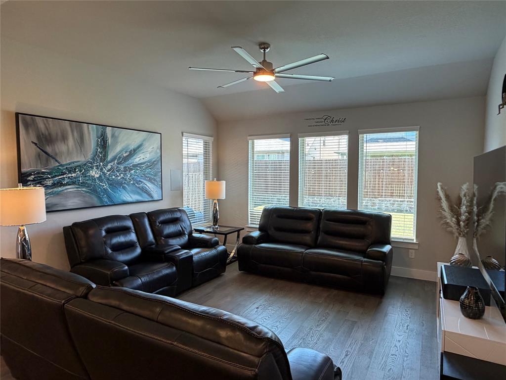 862 Mildren Lane Fate, TX 75087 - Photo 11 of 40 a living room with furniture and a flat screen tv with wooden floor