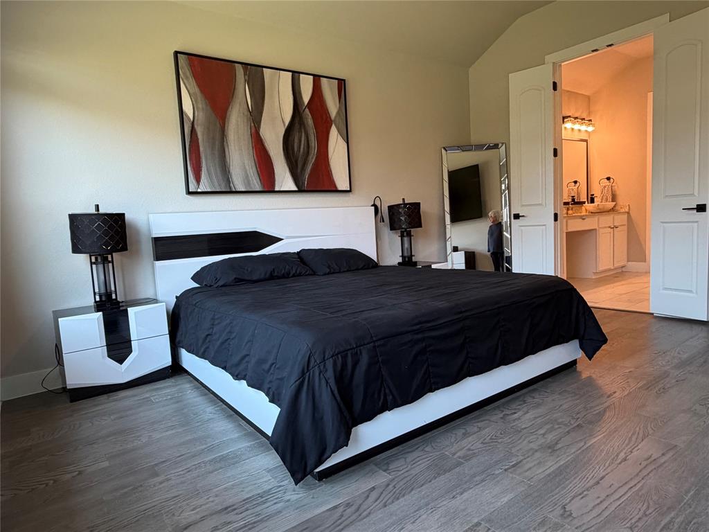 862 Mildren Lane Fate, TX 75087 - Photo 22 of 40 a bedroom with a bed and a painting on the wall