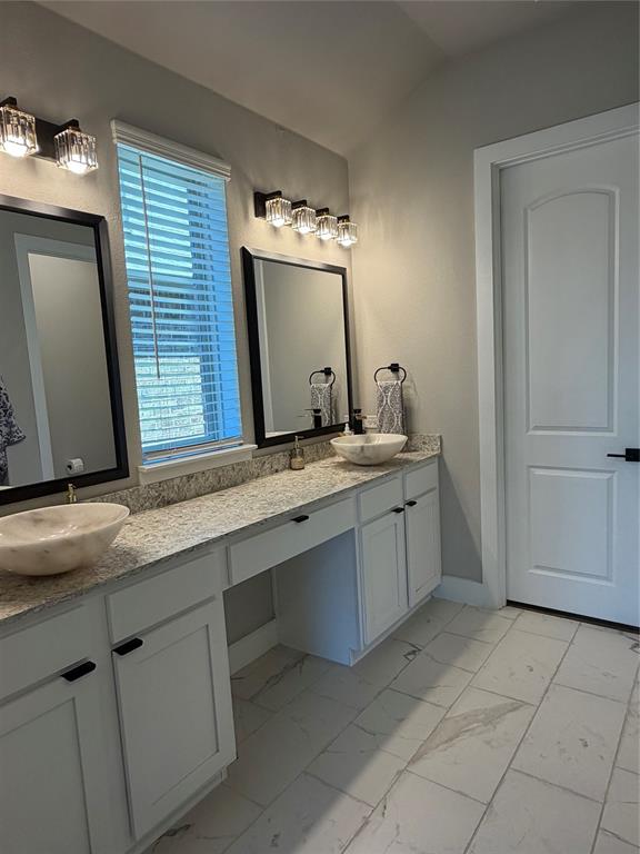 862 Mildren Lane Fate, TX 75087 - Photo 23 of 40 a bathroom with a sink and a mirror