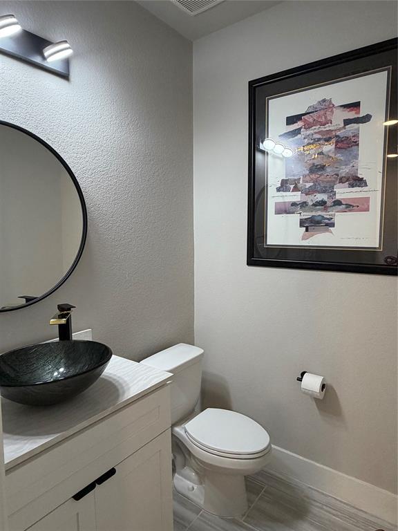 862 Mildren Lane Fate, TX 75087 - Photo 29 of 40 a bathroom with a toilet a sink and mirror