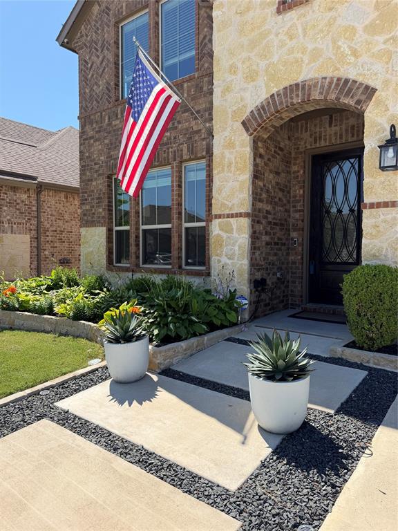 862 Mildren Lane Fate, TX 75087 - Photo 31 of 40 a front view of a house with potted plants