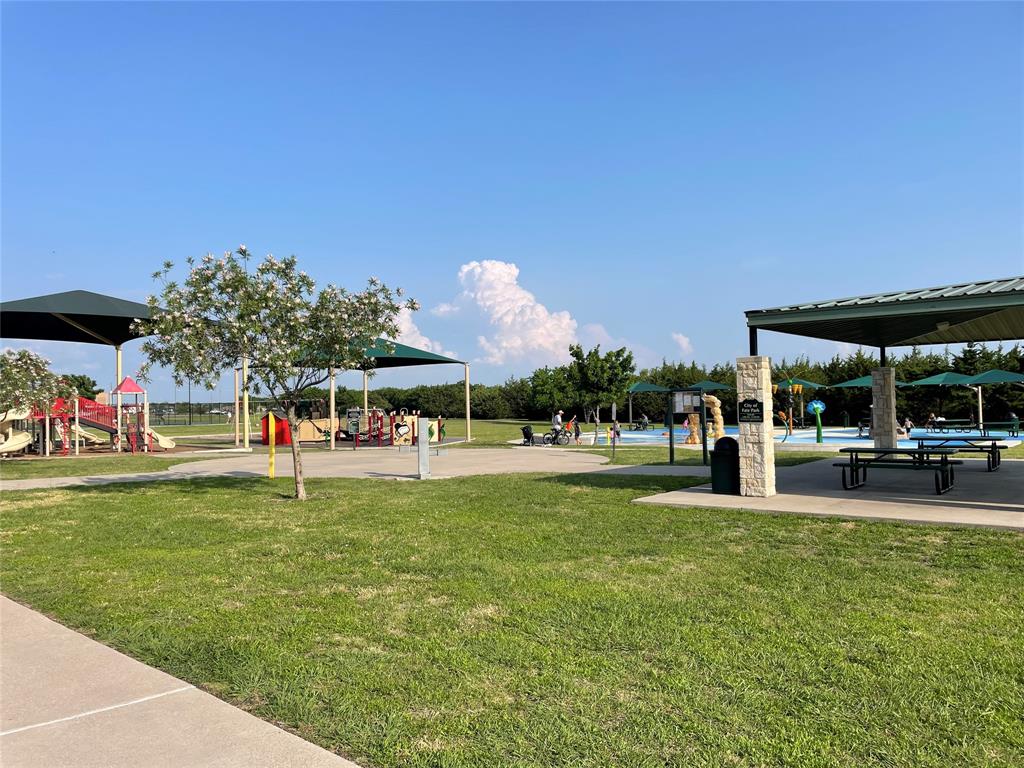 862 Mildren Lane Fate, TX 75087 - Photo 37 of 40 Nearest Playground, Splash Park and Covered Picnic Area. Path Through the Trees in the Background Has a Frisbee Golf Course.