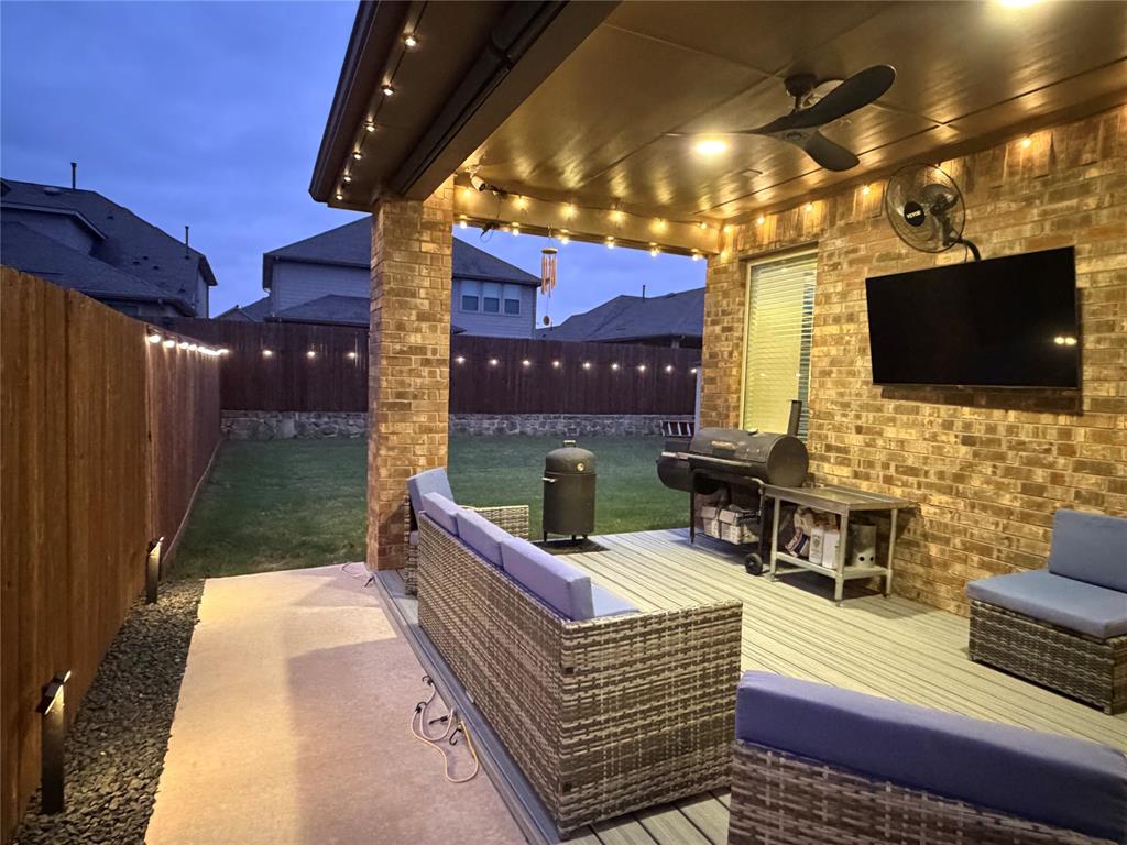 862 Mildren Lane Fate, TX 75087 - Photo 4 of 40 Comprehensive Lighting System that Illuminates the Covered Patio, Extended Deck, Fence and Entire Home Exterior Allowing Exciting Outdoor Entertainment.