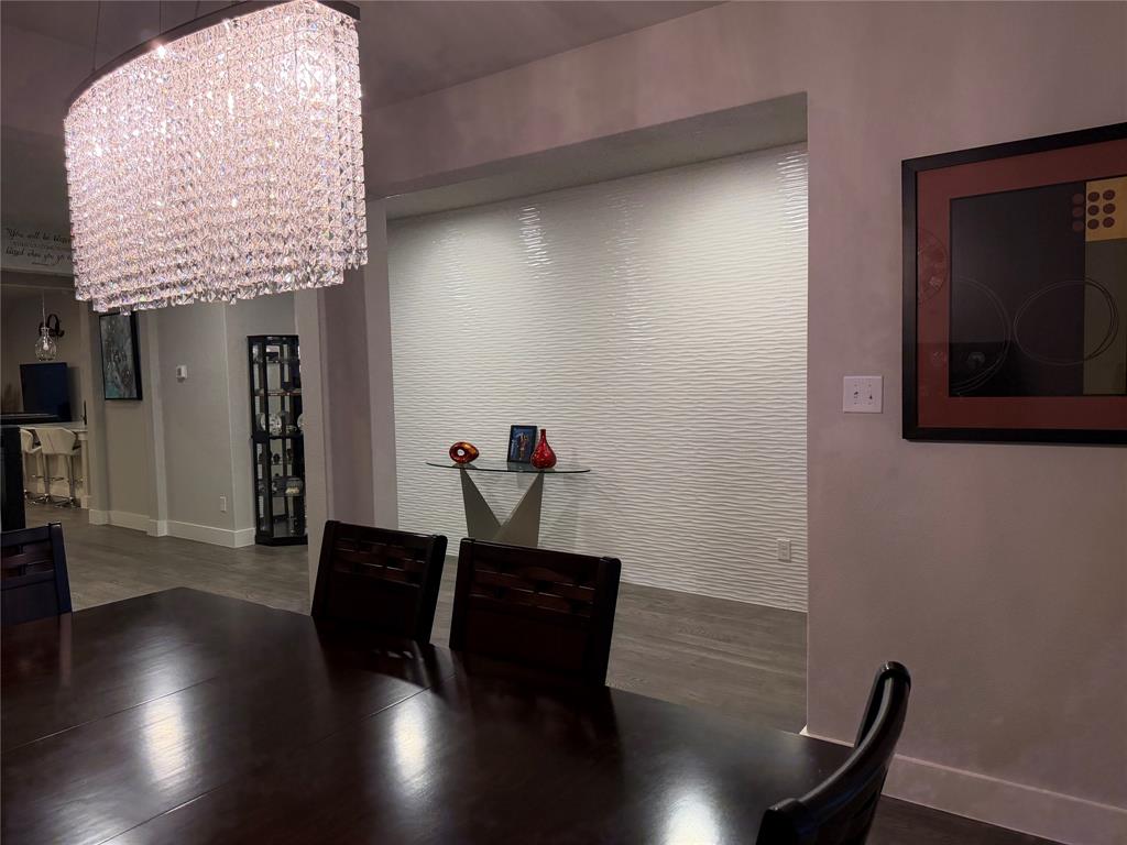 862 Mildren Lane Fate, TX 75087 - Photo 6 of 40 Spectacular Tiled Wall in Entry Is a Gorgeous Focal Point to Dining. Unique Modern Light Fixtures Throughout