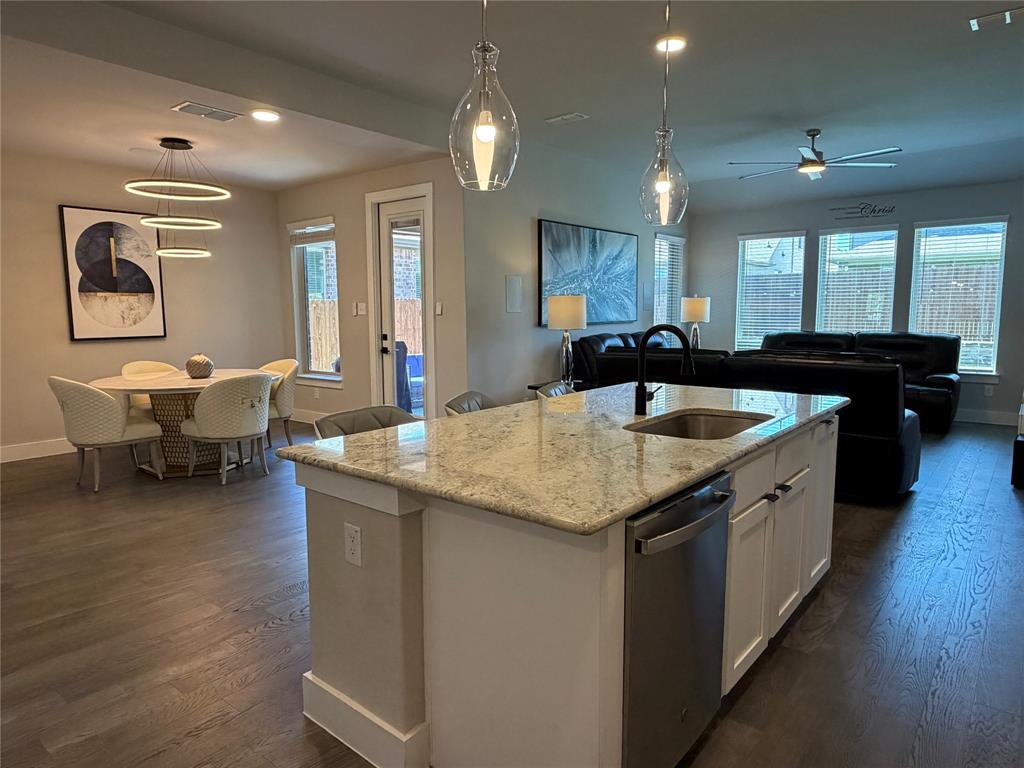 862 Mildren Lane Fate, TX 75087 - Photo 7 of 40 a kitchen with center island table and chairs