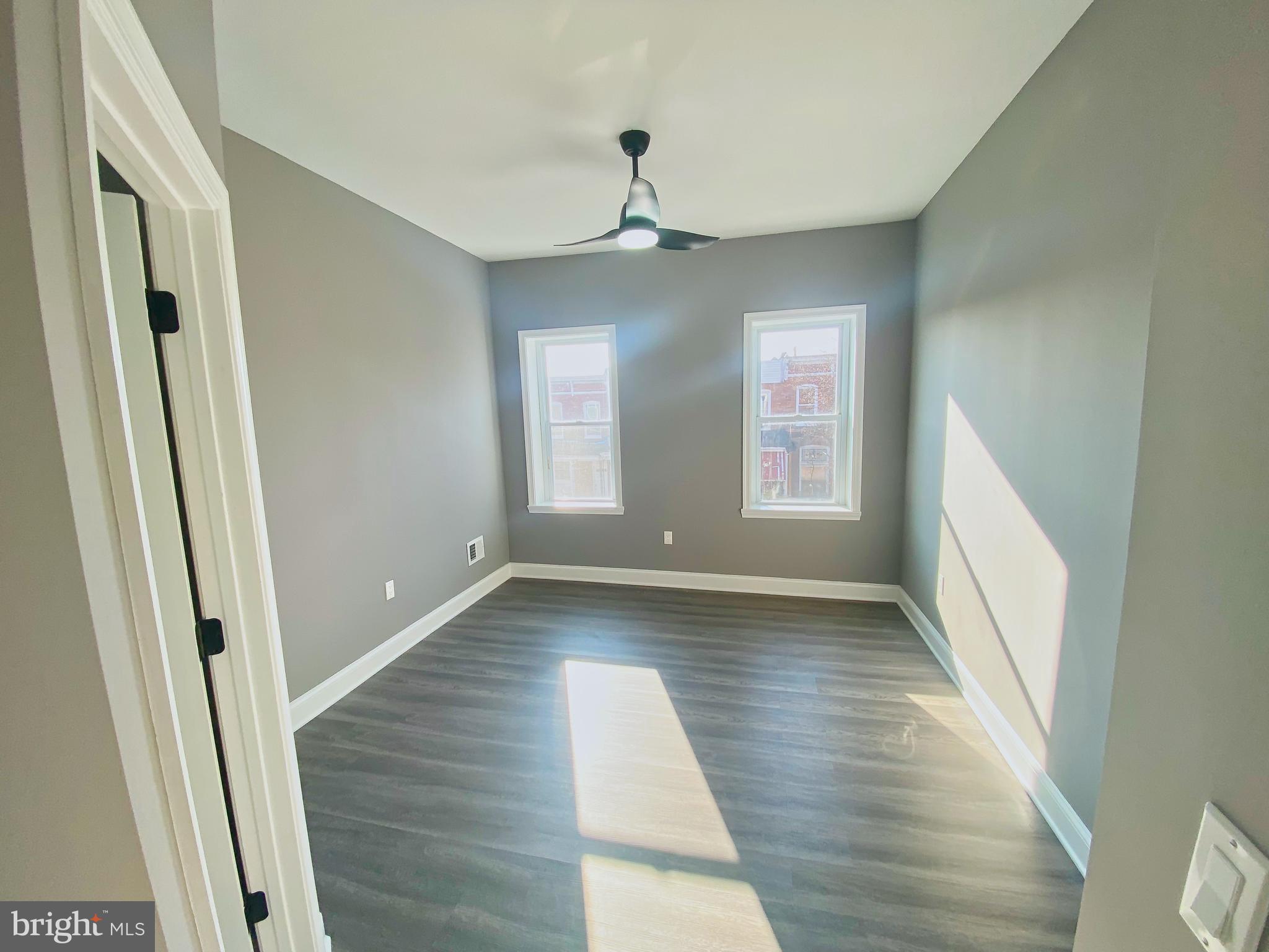 1604 Cliftview Avenue Baltimore, MD 21213 - Photo 13 of 34 a view of an empty room with wooden floor and a window