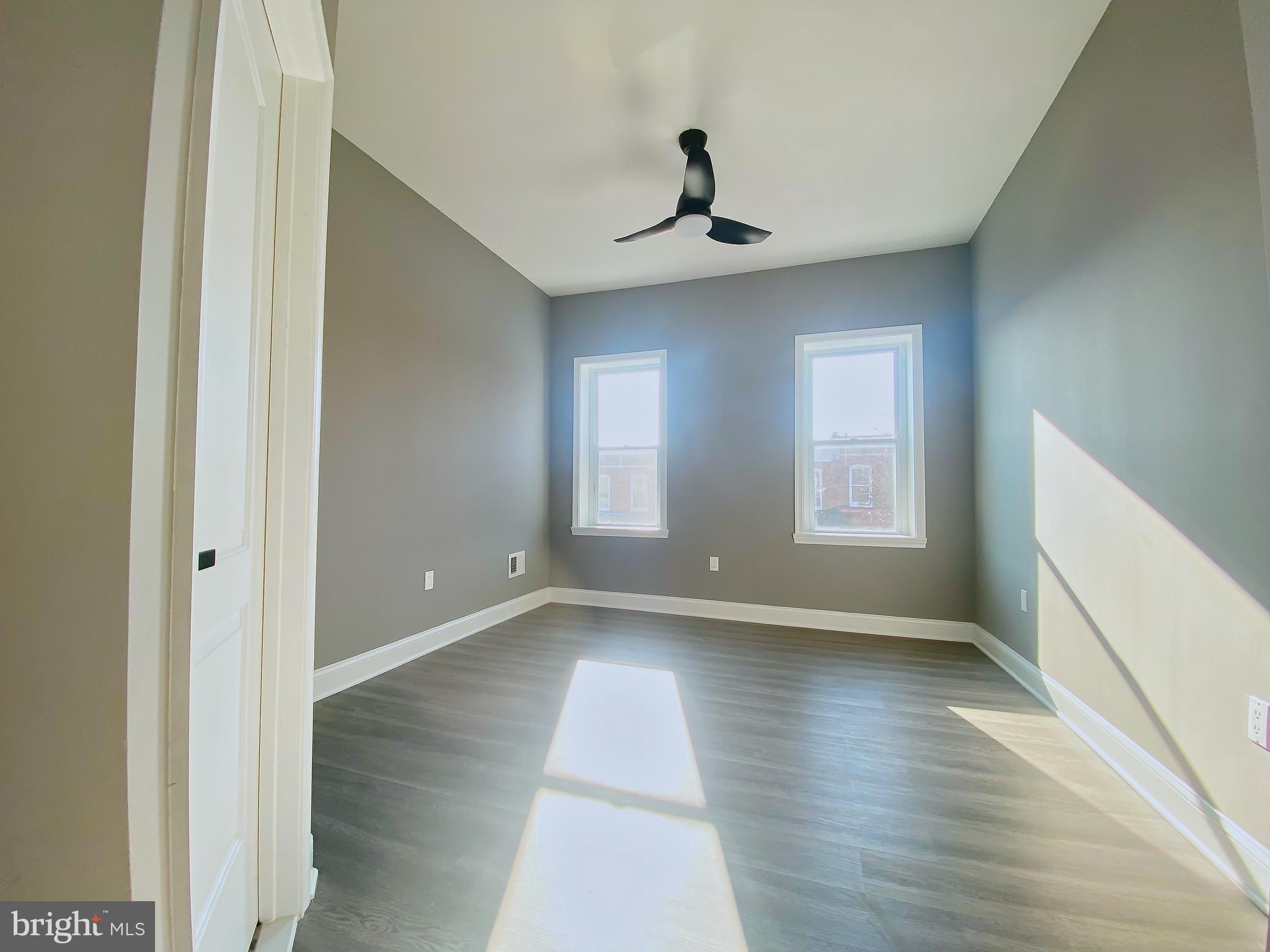1604 Cliftview Avenue Baltimore, MD 21213 - Photo 16 of 34 a view of an empty room with a window and wooden floor