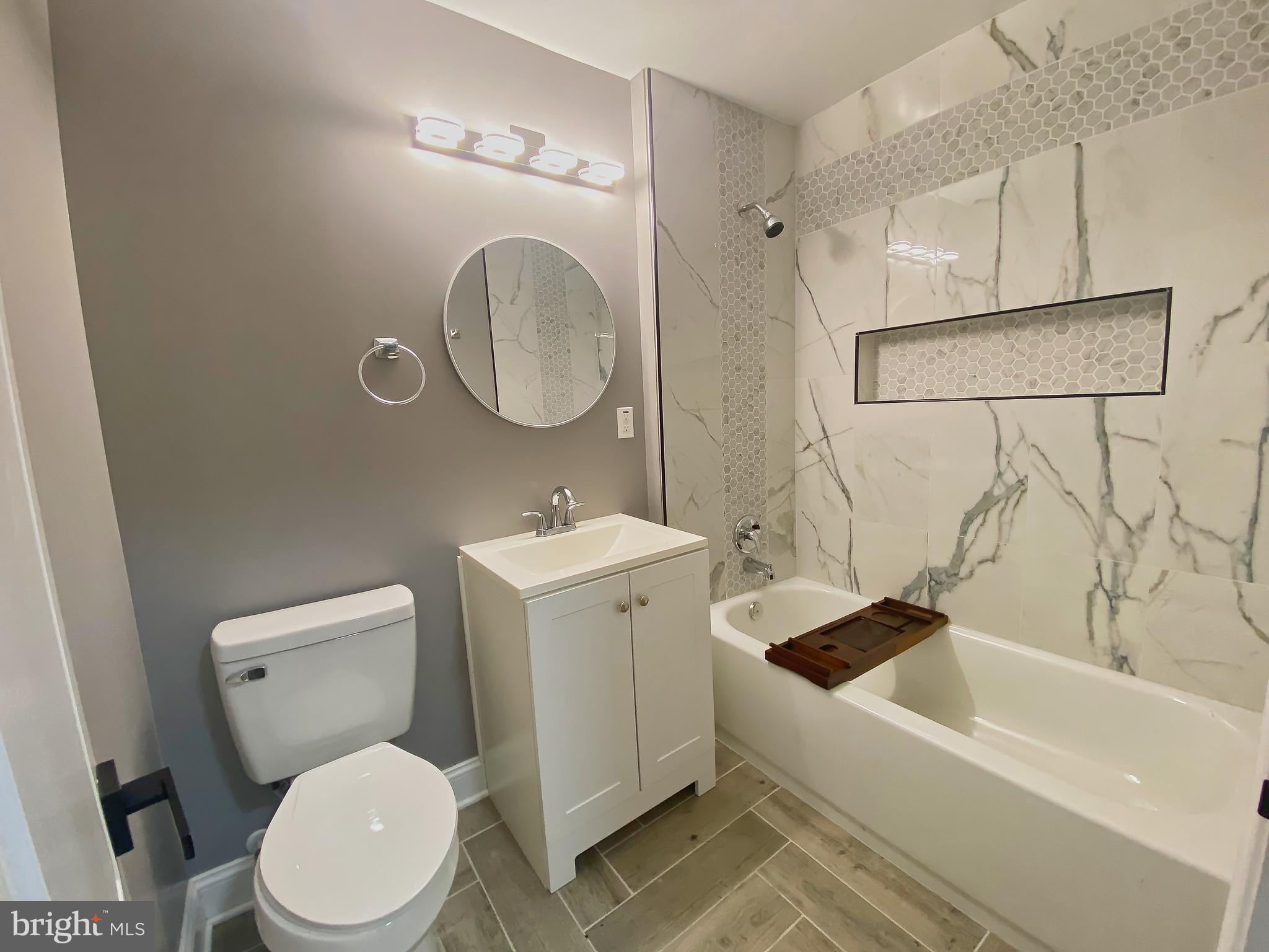 1604 Cliftview Avenue Baltimore, MD 21213 - Photo 19 of 34 a bathroom with a sink a toilet and a bathtub