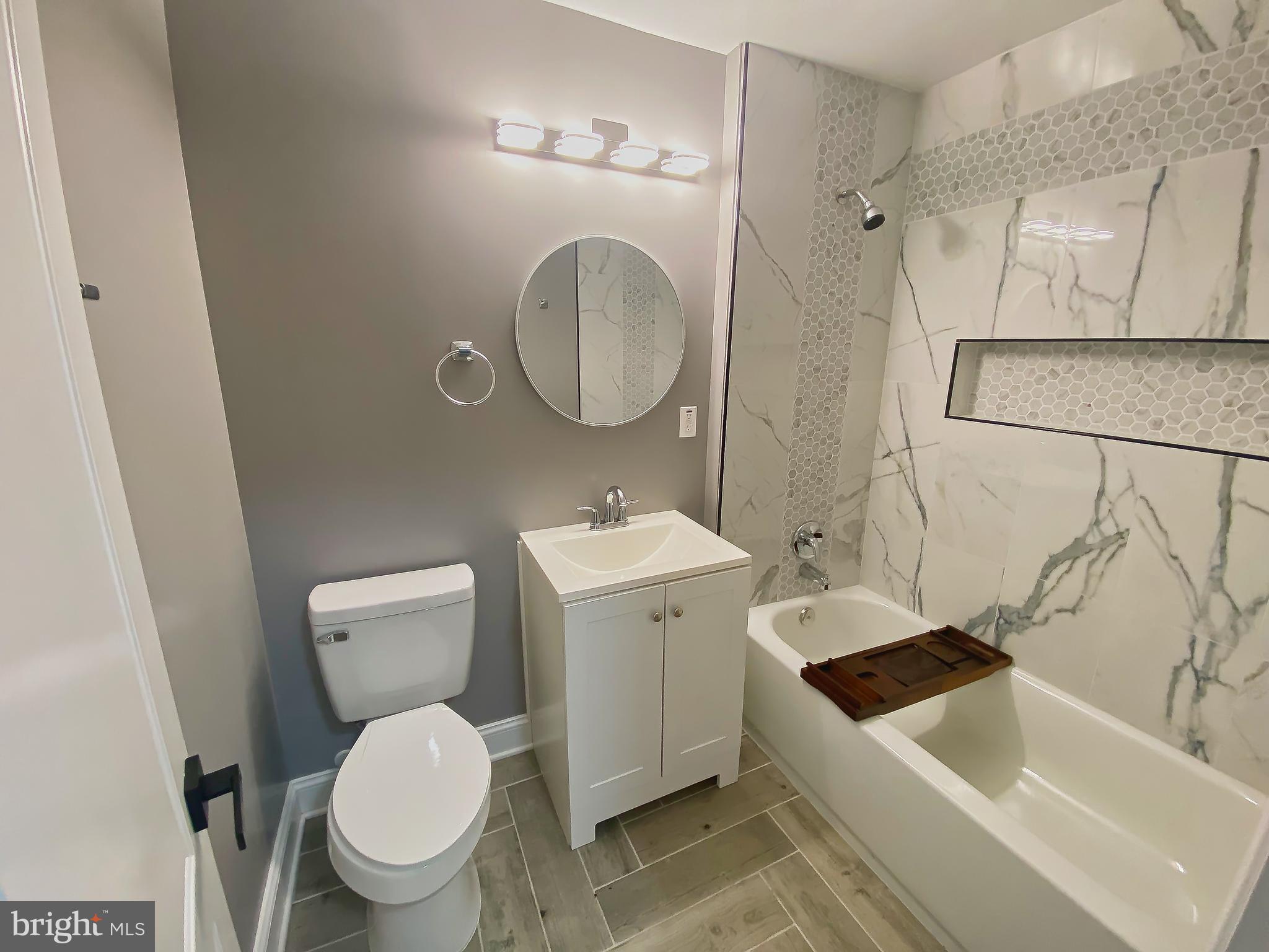 1604 Cliftview Avenue Baltimore, MD 21213 - Photo 22 of 34 a bathroom with a sink a toilet and a mirror