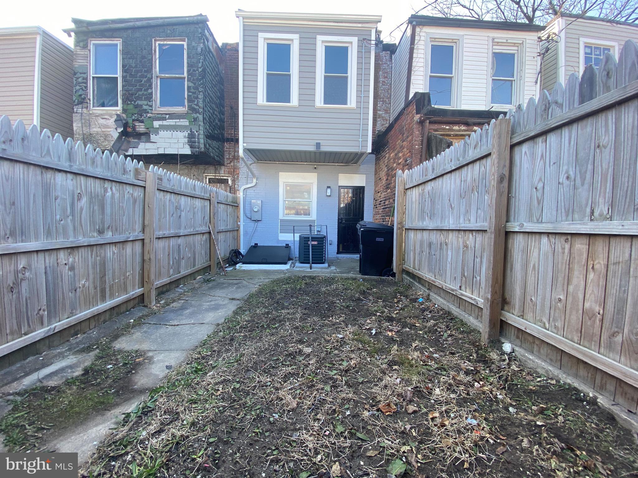 1604 Cliftview Avenue Baltimore, MD 21213 - Photo 31 of 34 a view of a house with a backyard and wooden fence
