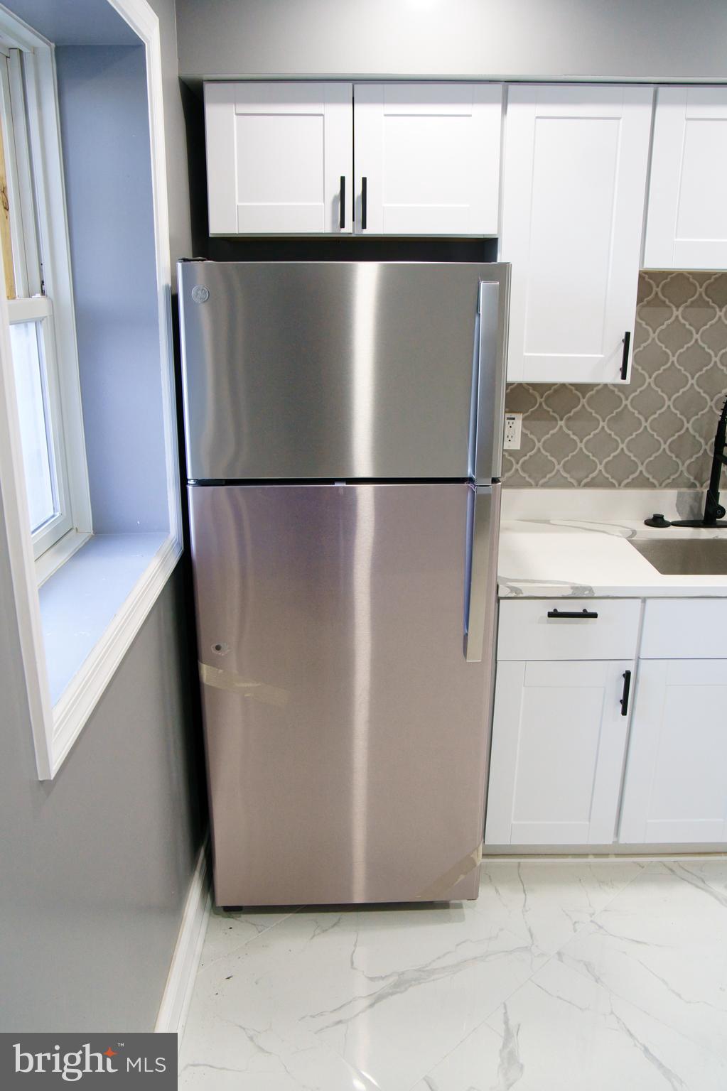 1604 Cliftview Avenue Baltimore, MD 21213 - Photo 7 of 34 a view of a refrigerator in kitchen and an empty room